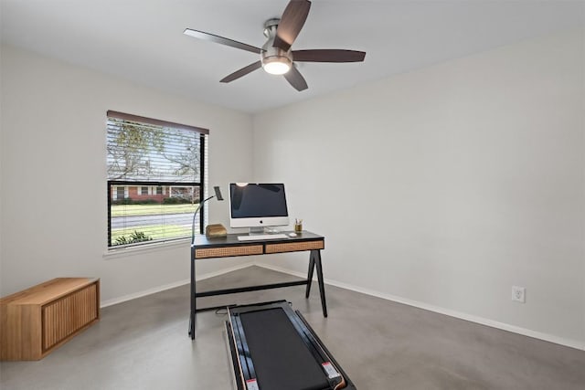 office space with finished concrete flooring, baseboards, and a ceiling fan