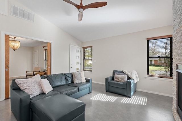 living area featuring visible vents, plenty of natural light, a stone fireplace, and vaulted ceiling