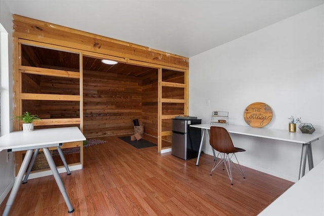 office space featuring wooden walls and wood finished floors