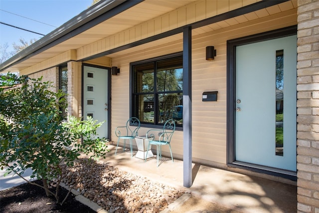 view of exterior entry with a porch