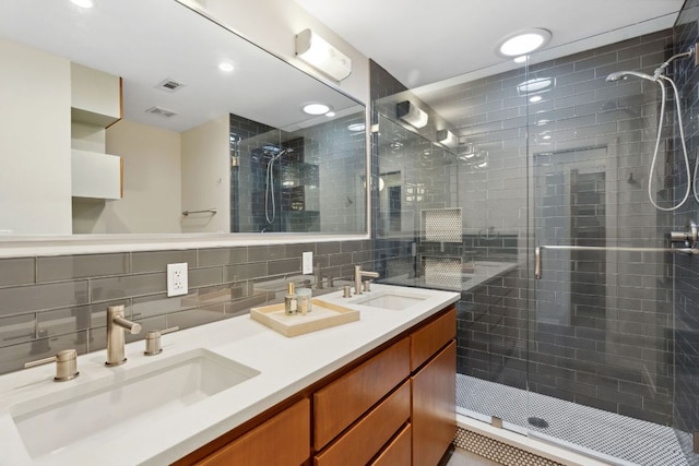 4810 Enchanted Ln, Austin, TX 78745 - bathroom with a shower stall, double vanity, tasteful backsplash, tile walls, and recessed lighting