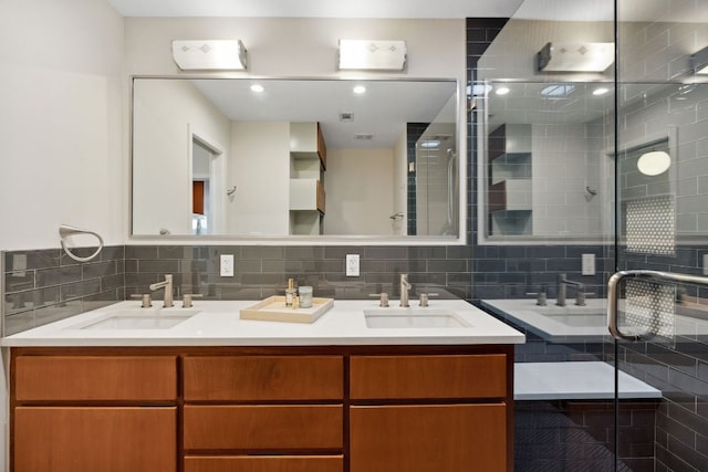 4810 Enchanted Ln, Austin, TX 78745 - bathroom featuring double vanity, a shower stall, and backsplash