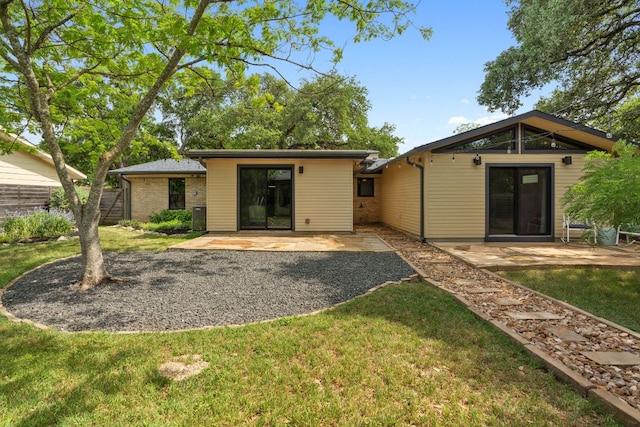 4810 Enchanted Ln, Austin, TX 78745 - back of property featuring a patio area and a yard