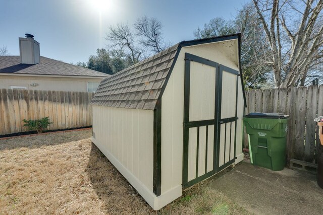 view of shed with a fenced backyard