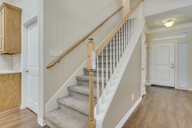 stairway with baseboards and wood finished floors