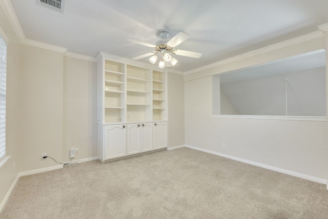 unfurnished room featuring light colored carpet, visible vents, ornamental molding, a ceiling fan, and baseboards