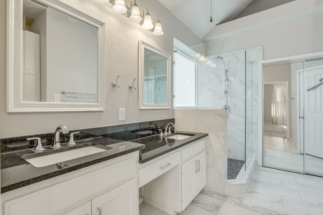 full bathroom with vaulted ceiling, marble finish floor, a sink, and a marble finish shower