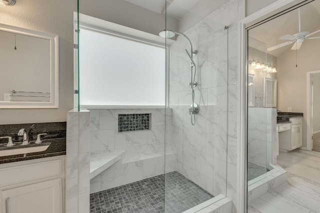 full bath featuring marble finish floor, ceiling fan, vanity, and a marble finish shower