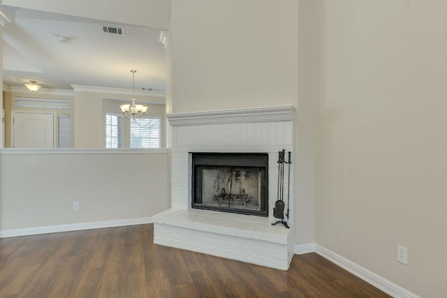 unfurnished living room featuring dark wood-style floors, a fireplace, visible vents, ornamental molding, and baseboards