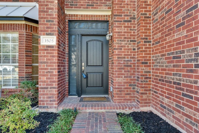 property entrance with brick siding