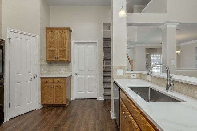 kitchen featuring dark wood-style floors, brown cabinets, backsplash, stainless steel dishwasher, and a sink