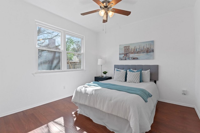 bedroom with wood finished floors, baseboards, and ceiling fan