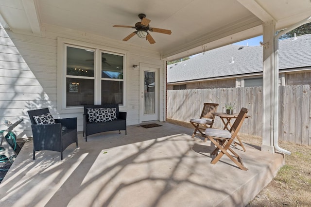 view of patio featuring ceiling fan and fence