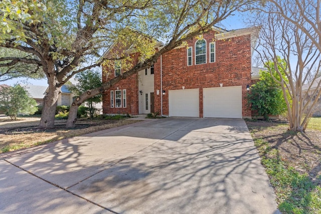 view of front facade featuring brick siding, driveway, and an attached garage