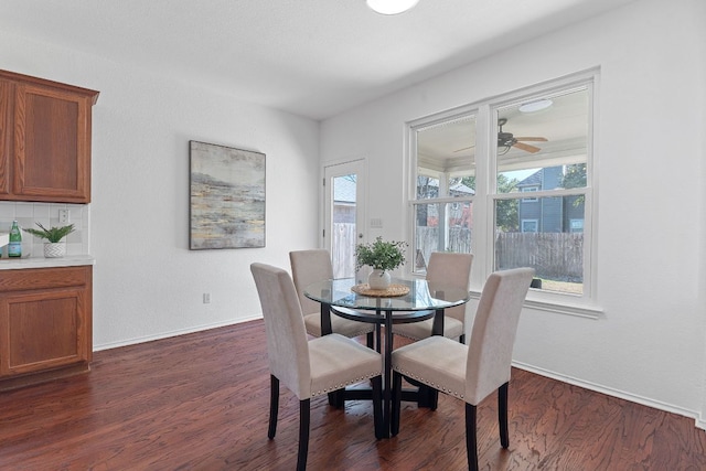 dining area featuring dark wood-style floors, baseboards, and ceiling fan