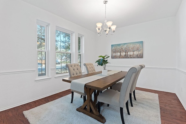 dining space with a wealth of natural light, a notable chandelier, and dark wood-style flooring