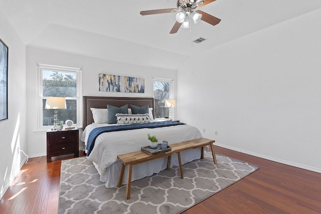 bedroom featuring ceiling fan, wood finished floors, visible vents, and baseboards