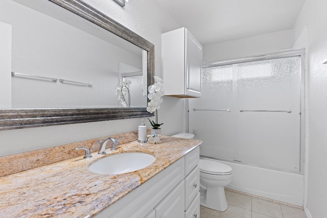 bathroom featuring tile patterned floors, toilet, vanity, and bathtub / shower combination