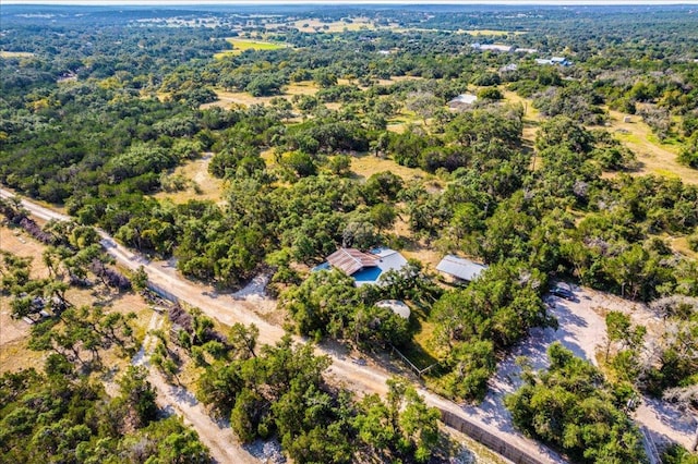 birds eye view of property featuring a view of trees