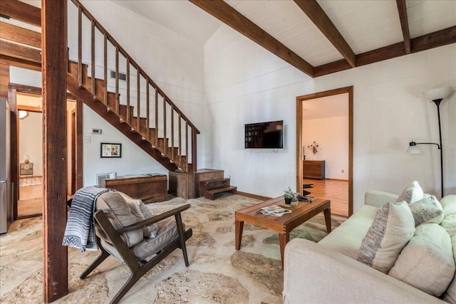 living area with stairs and beam ceiling