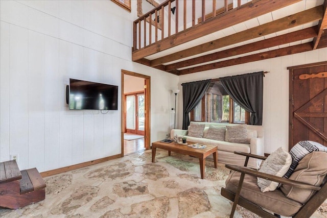 living room with wood walls and beamed ceiling