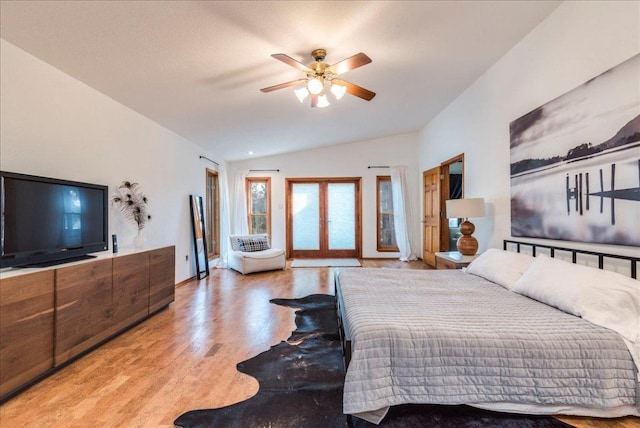 bedroom featuring ceiling fan, light wood-style floors, vaulted ceiling, access to outside, and french doors