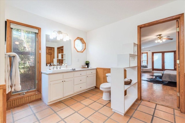 bathroom featuring toilet, plenty of natural light, ensuite bath, and vanity