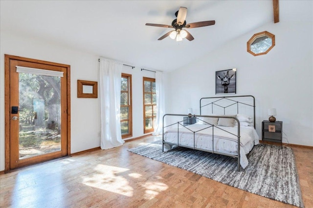 bedroom featuring wood finished floors, a ceiling fan, baseboards, vaulted ceiling, and access to exterior