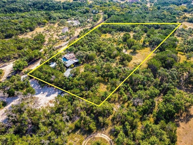 drone / aerial view featuring a forest view