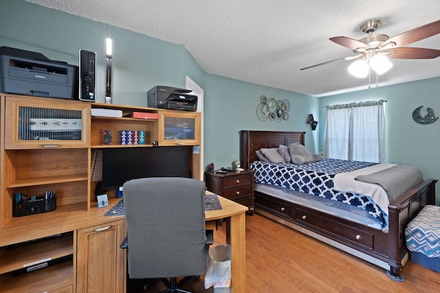 bedroom featuring wood finished floors and a textured ceiling