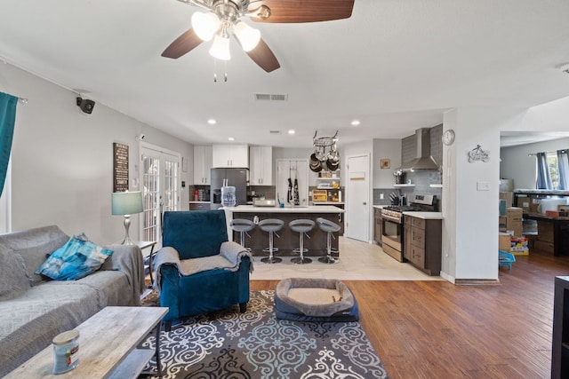 16700 Black Kettle Dr, Leander, TX 78641 - living room featuring french doors, light wood-style flooring, visible vents, ceiling fan, and recessed lighting