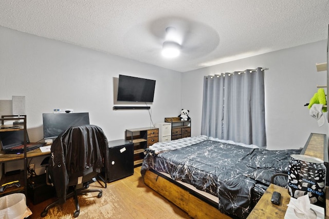 16700 Black Kettle Dr, Leander, TX 78641 - bedroom with a textured ceiling, wood finished floors, and a ceiling fan