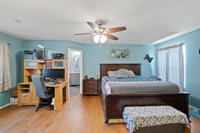 16700 Black Kettle Dr, Leander, TX 78641 - bedroom with connected bathroom, a textured ceiling, light wood-style flooring, and a ceiling fan