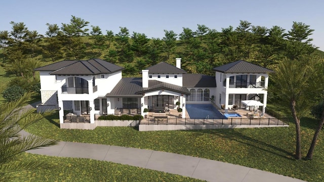 rear view of house featuring a patio, an outdoor hangout area, a standing seam roof, metal roof, and a balcony