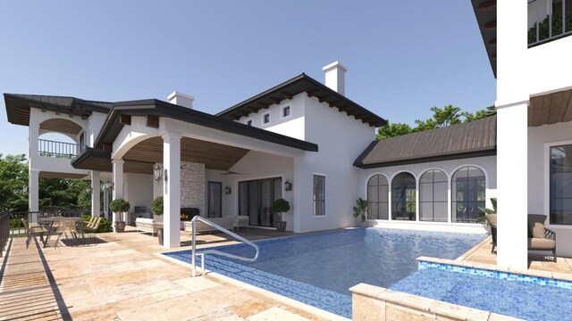 view of swimming pool featuring an infinity pool, ceiling fan, and a patio