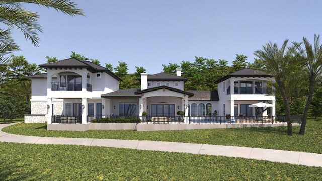 view of front of home featuring fence private yard, a balcony, a front yard, and stucco siding