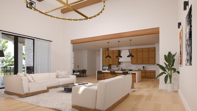 living area featuring light wood-type flooring, a towering ceiling, and baseboards