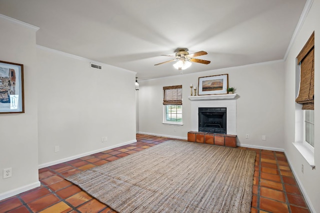 unfurnished living room featuring crown molding, visible vents, a fireplace, and ceiling fan