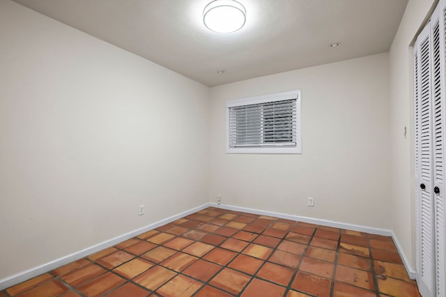 empty room featuring baseboards