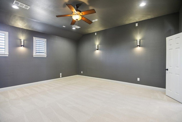 unfurnished room with visible vents, carpet floors, baseboards, and a ceiling fan