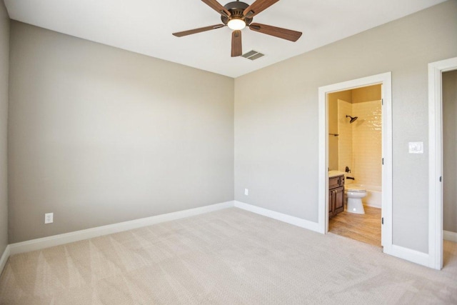 empty room with visible vents, light colored carpet, baseboards, and ceiling fan