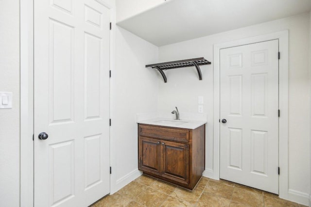 interior space with vanity and baseboards