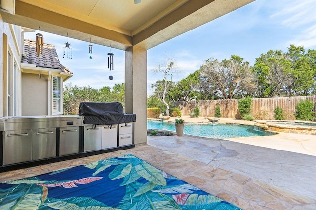 view of patio / terrace with a pool with connected hot tub, area for grilling, a grill, and fence