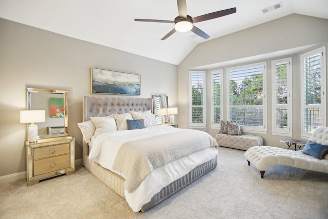 bedroom with lofted ceiling, light colored carpet, visible vents, and baseboards