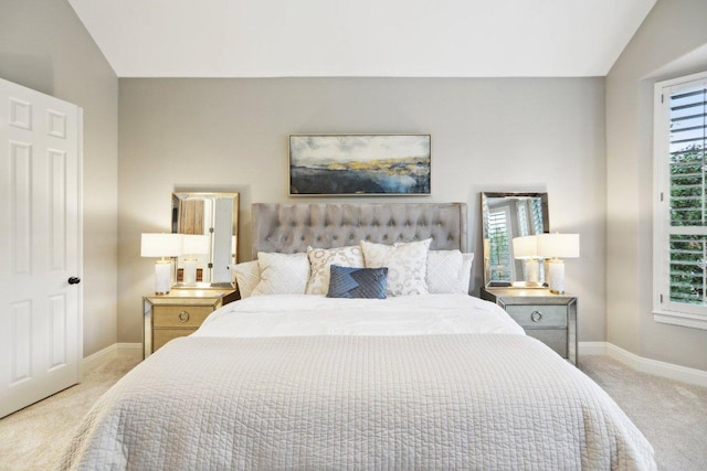 bedroom featuring vaulted ceiling, baseboards, and carpet floors