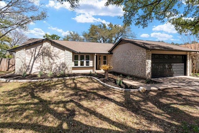 view of front of home featuring a garage, stone siding, and concrete driveway