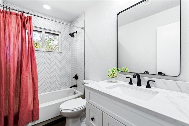 full bath with a textured wall, toilet, visible vents, vanity, and shower / bath combo with shower curtain