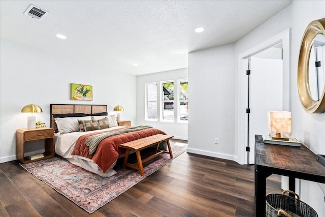 bedroom with dark wood finished floors, recessed lighting, and baseboards