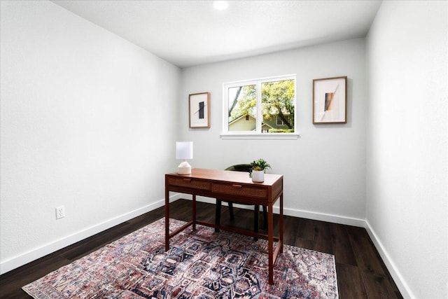 office area featuring dark wood finished floors and baseboards