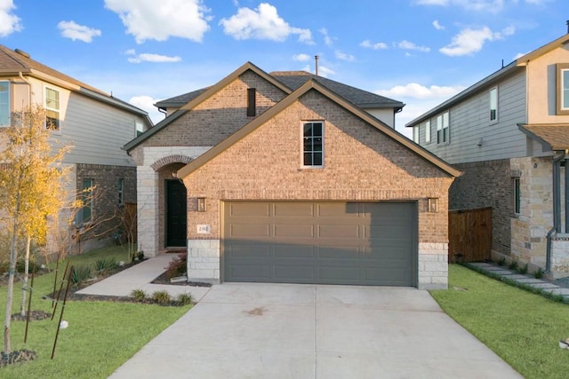 view of front facade featuring an attached garage, concrete driveway, and brick siding